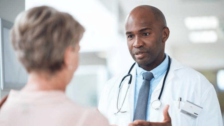 male audiologist/ENT speaking with a female patient