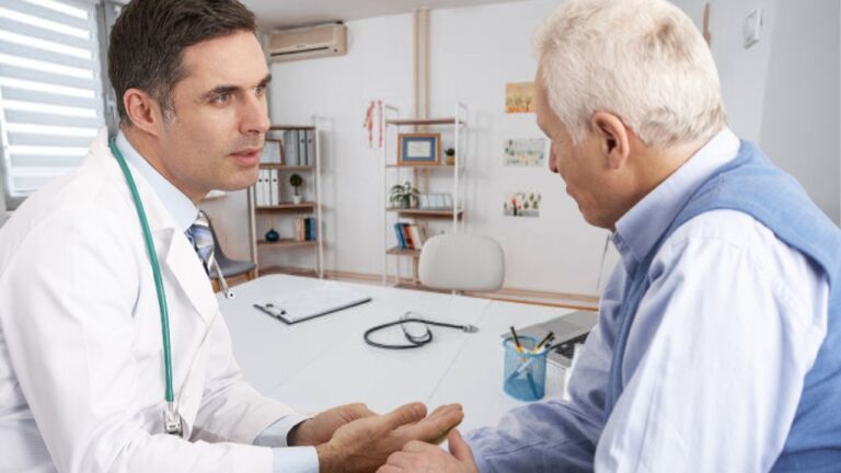 older man talking to his doctor about reactive tinnitus