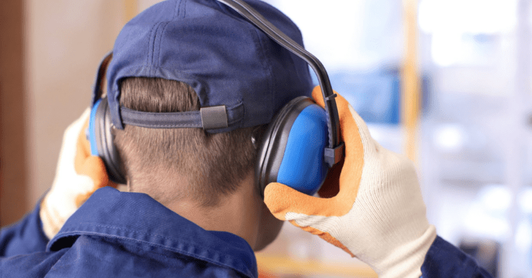 person wearing earmuffs for protection from loud sounds