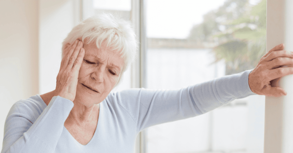 woman grabbing her ear in pain
