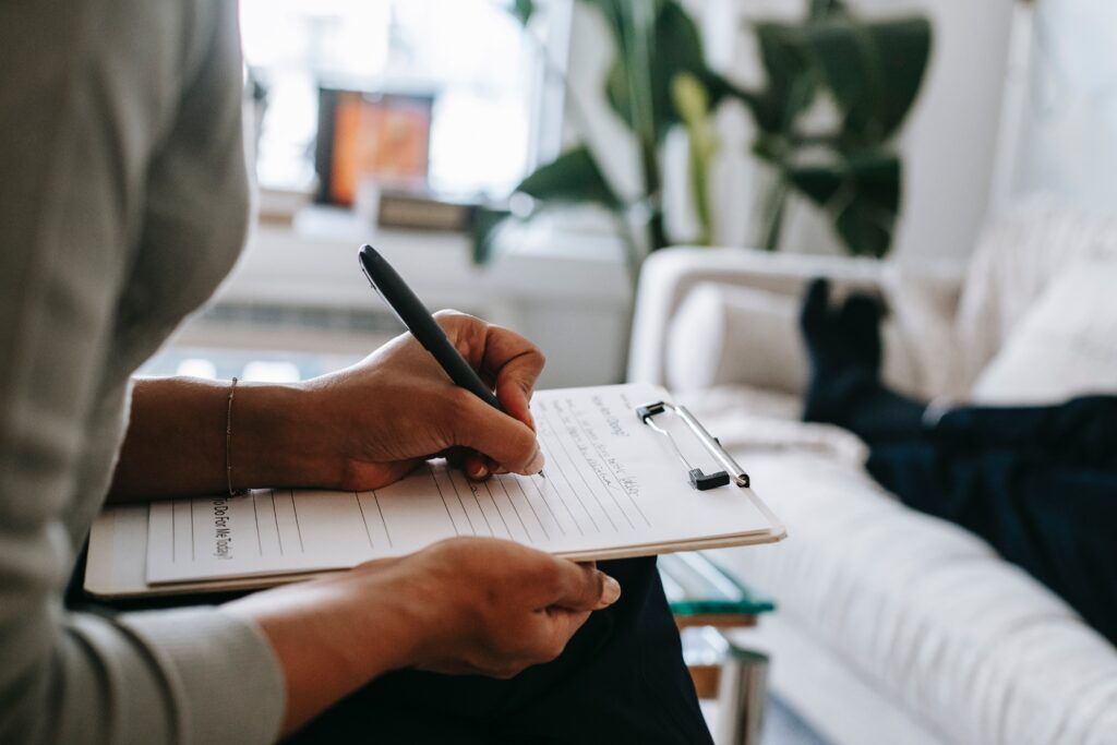 Doctor taking notes on a clipboard