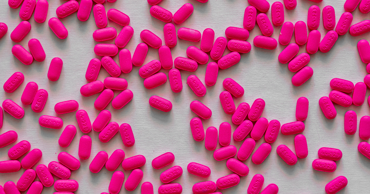 Pink pills scattered on a counter