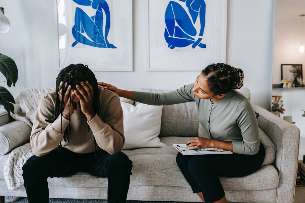 Patient sitting on a couch talking to a therapist