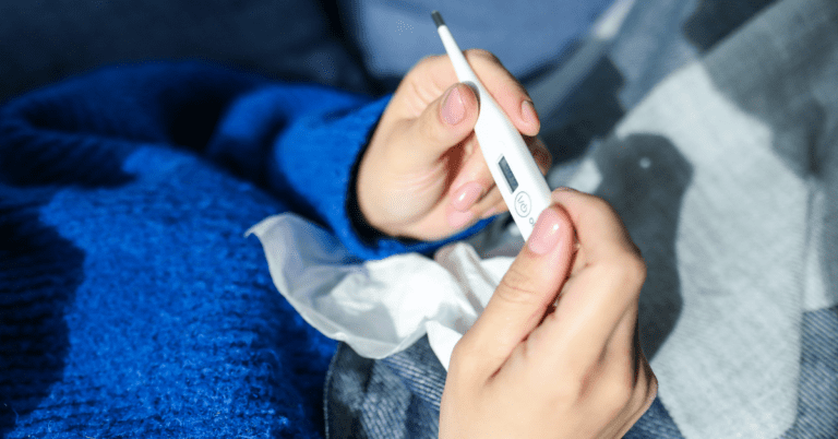 Person with a thermometer in their hand