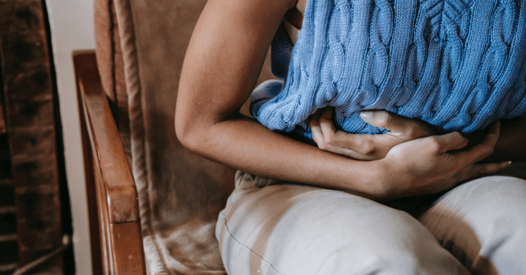 Woman holding her stomach in pain