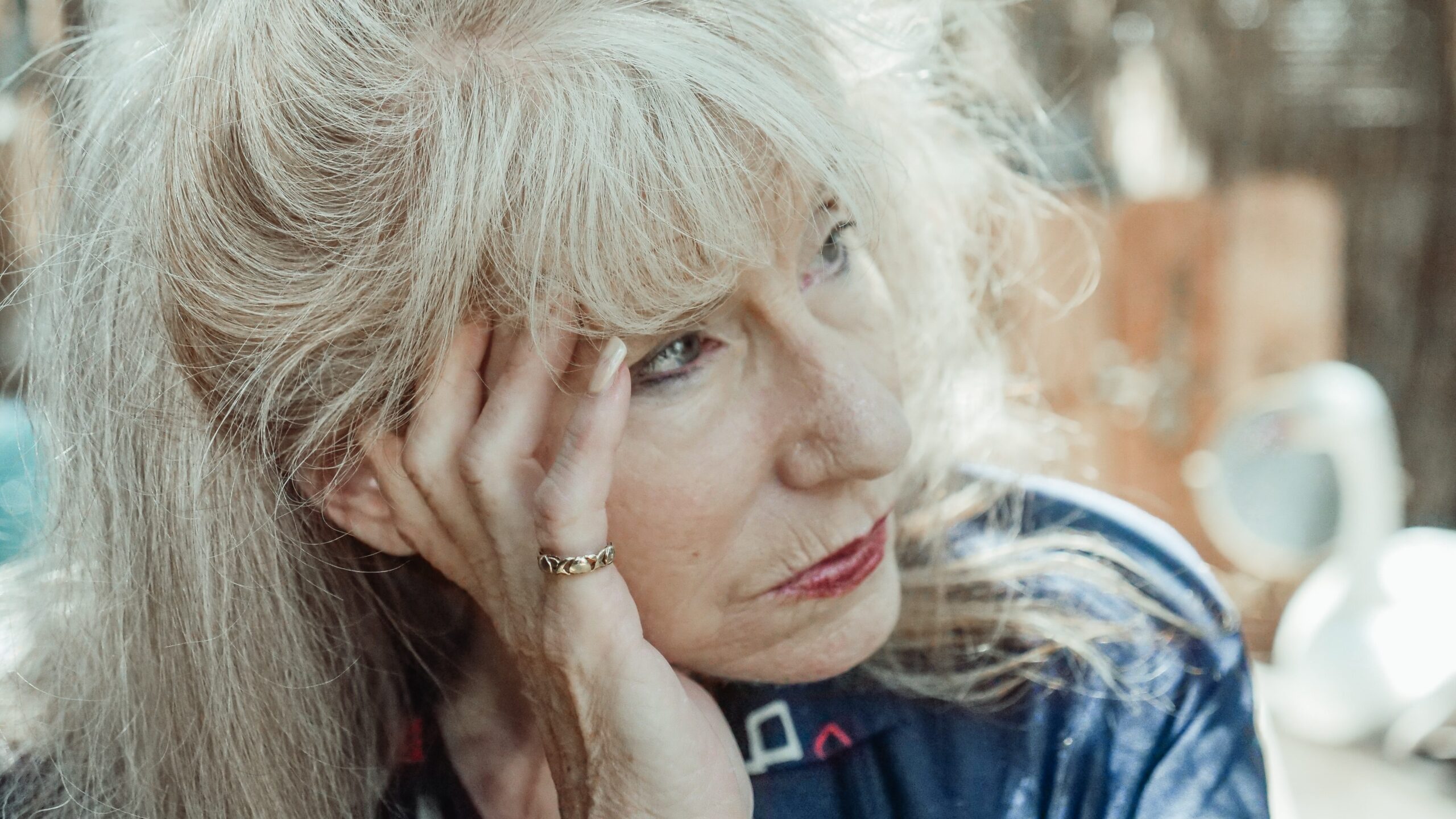 Woman sitting with her hand resting on her face