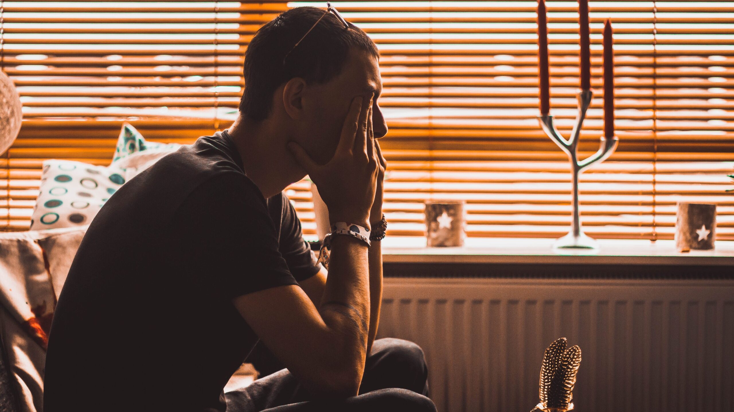 Man stressed out holding his head in his hands