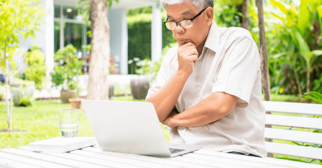 Man at a computer doing research about tinnitus