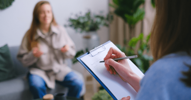 Doctor talking to a patient and taking notes