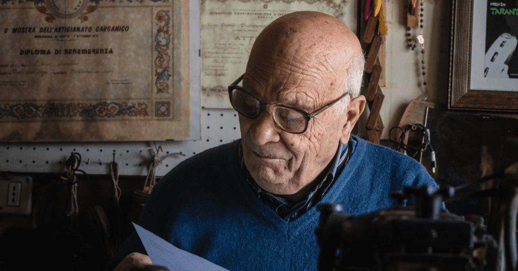 Old man reading a piece of paper