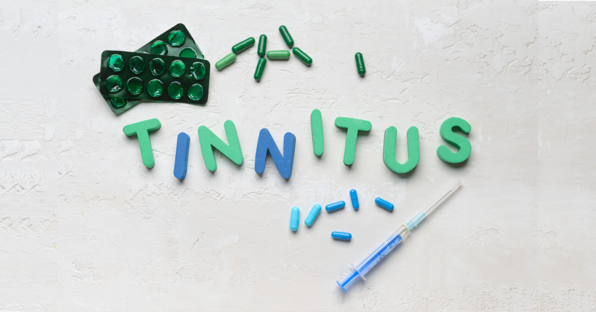 Letters that spell the word tinnitus with pills surrounding it