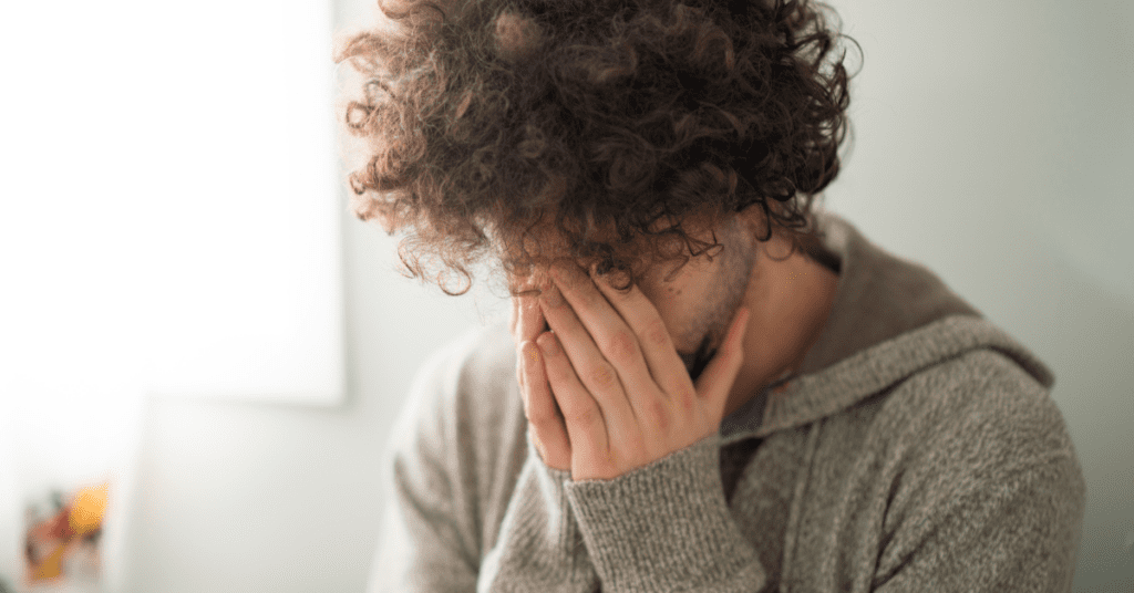 Man holding his head in his hands due to being stressed