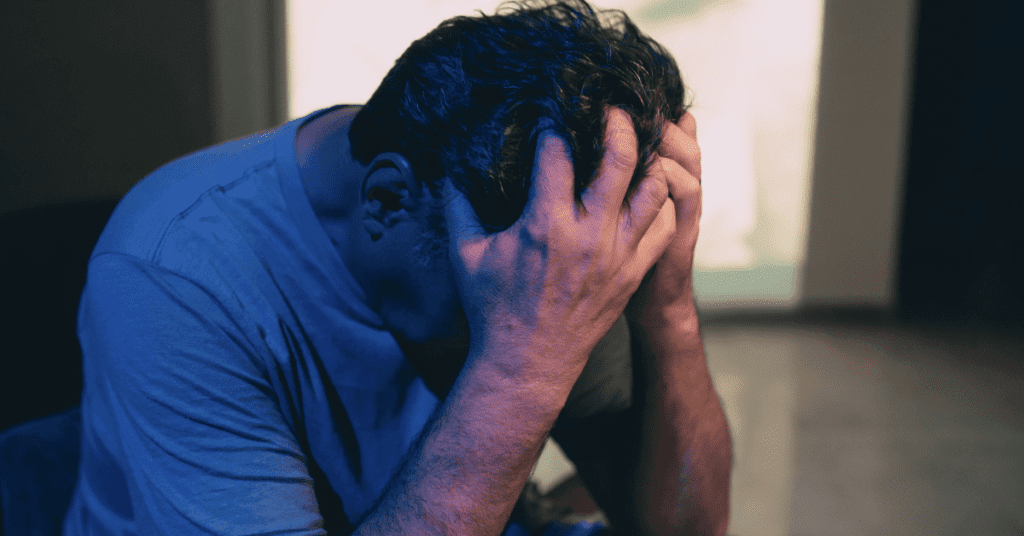 Man holding his head in his hands due to being stressed out