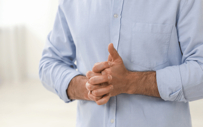 Man cracking his knuckles and making a popping sound