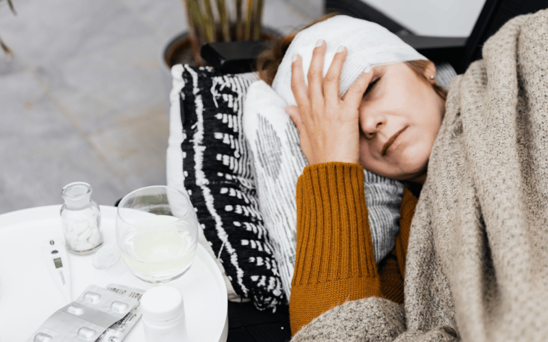 Woman laying down with a bandage on her head 