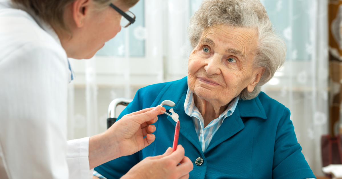 Old woman with hearing loss getting fit for hearing aids