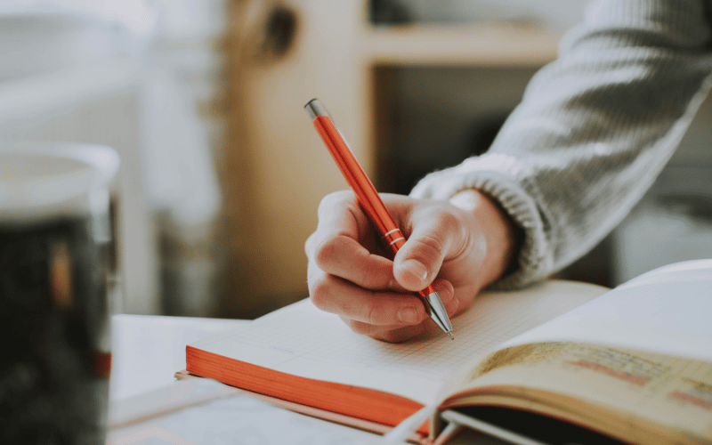 Person writing in a notebook