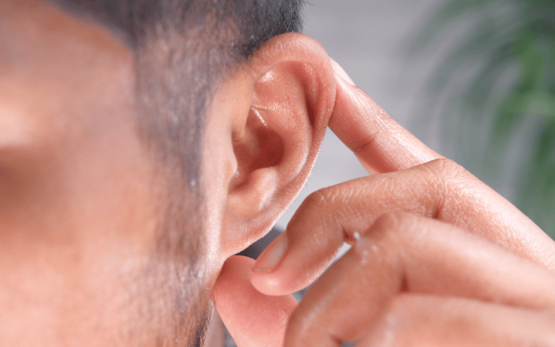 Man holding his ear
