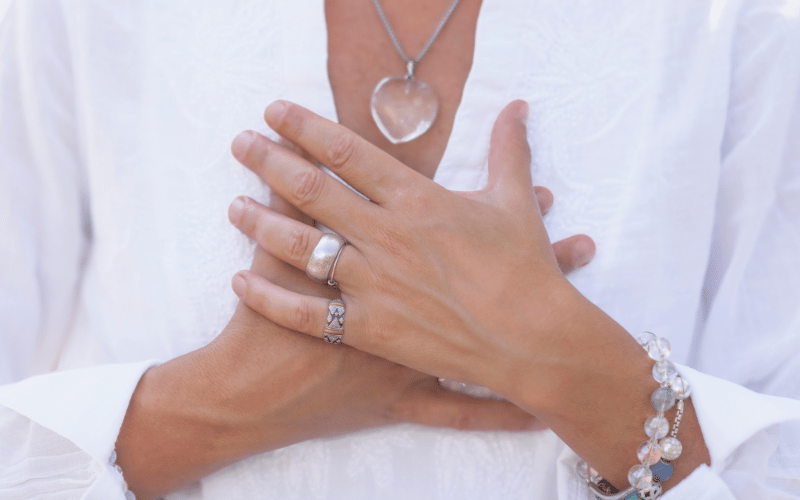 Woman with overlapping hands over her chest