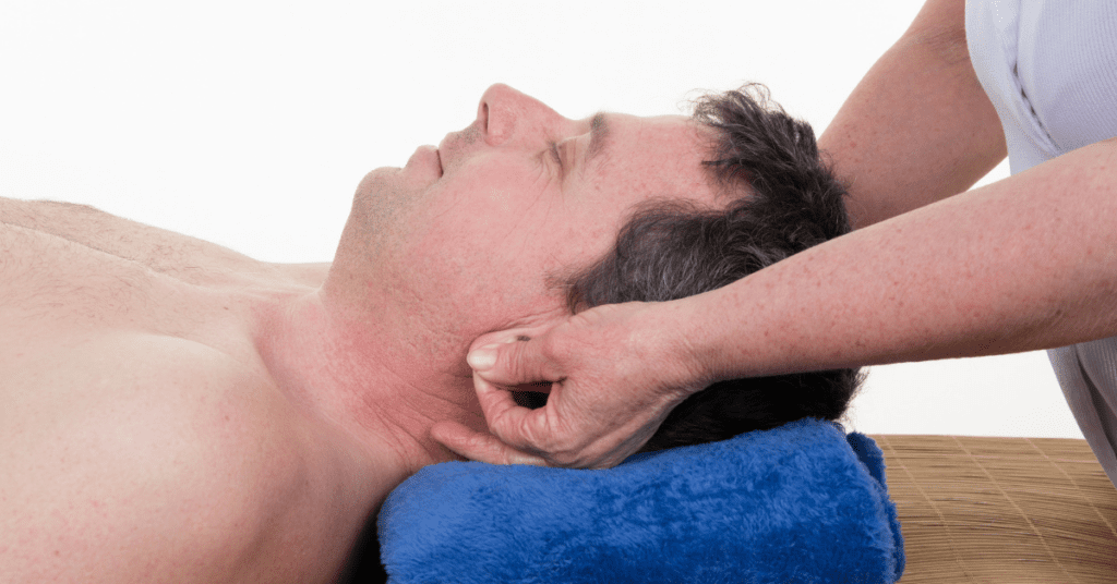 Man in an ear reflexology session