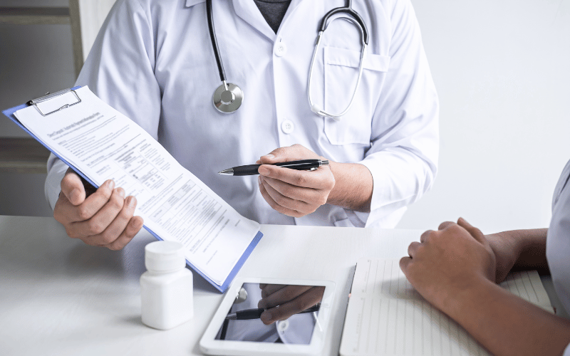 Doctor showing a patient a clipboard with information