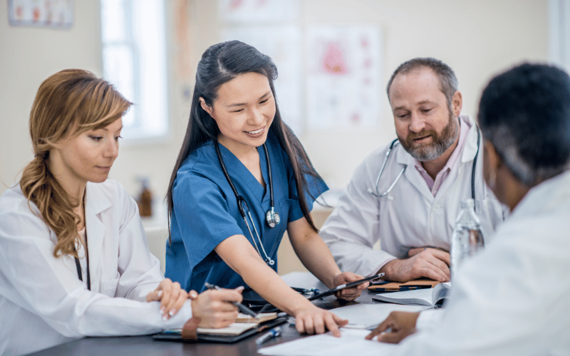 Team of doctors reviewing test results and speaking with each other
