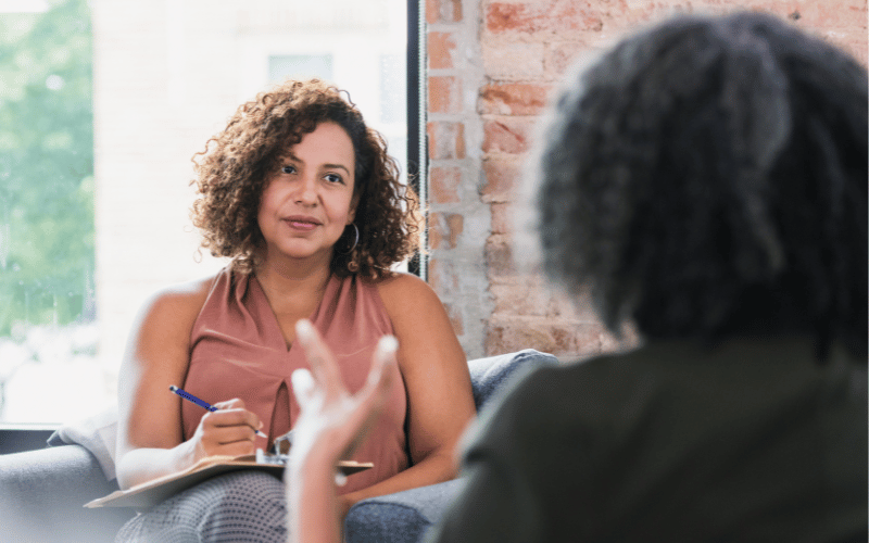 Two women speaking with each other