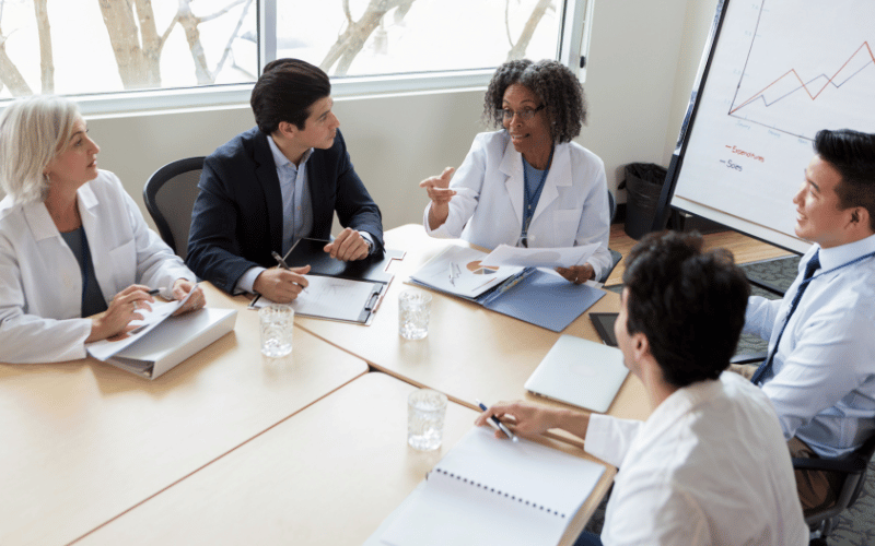 Group of researchers sitting around a table and talking to each other