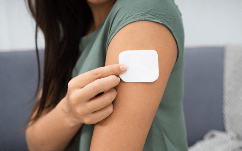 Person applying a lidocaine patch